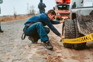 A man pumps air wheel with a compressor photo