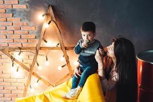 Mother and little son play at home photo