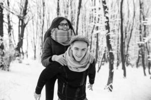 Happy couple playful together in snow park photo