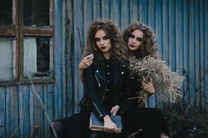 Two vintage witches gathered eve of Halloween photo