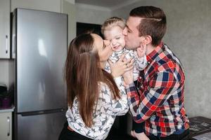 Mom, Dad and little girl having fun together photo