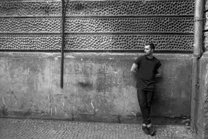 The man in the authentic boots and selvedge jeans  on a background of old city photo