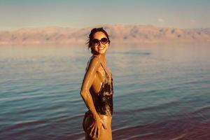 A young woman enjoying the natural mineral mud photo