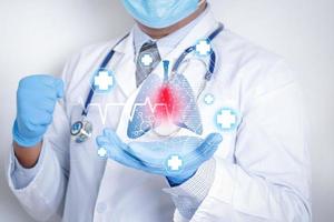 Doctors wearing masks and gloves Shows a graphical computer interface connected to a medical network. Treatment of lung disease caused by the coronavirus. Concept of health care and medical technology photo