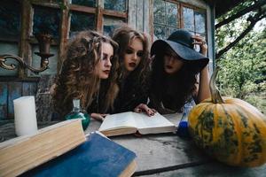 Three vintage witches perform magic ritual photo