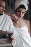 Guy in a white coat and a girl in a towel photo