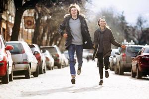 guy and the girl having fun on a city street photo