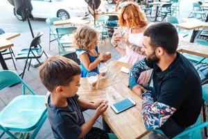 family in a cafe, mom takes a photo