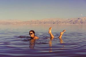 Girl is relaxing and swimming in the water photo