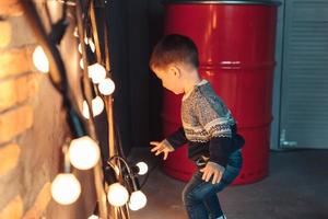 little boy plays with light bulbs photo