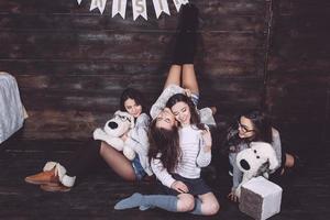 Four charming model posing on a vintage New Year's background photo