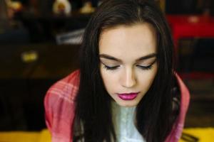 Close-up portrait of young closing eyes woman photo