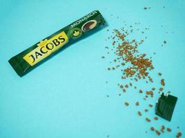 Kazan, Russia 10-18-2021 Opened disposable coffee bag. Jacobs monarch, arabica. Sprinkled coffee granules photo