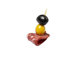 Kanape.  Slicing salami and olives on toothpicks. photo