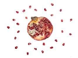 Cut pomegranate with grains on a white background, half a pomegranate photo