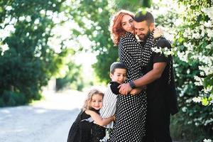 Mom, Dad, little son and daughter have fun photo