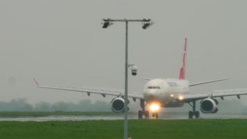 ALMATY, KAZAKHSTAN MAY 4, 2019 - Turkish Cargo Airbus A330 TC JDR braking after landing on runway at rainy weather. Airport of Almaty, Kazakhstan video