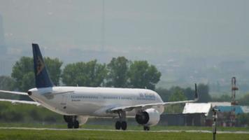 ALMATY, KAZAKHSTAN MAY 4, 2019 - Commercial airplane of Air Astana taxiing on the runway at Almaty airport, Kazakhstan. Airliner driving on the airfield, long shot video