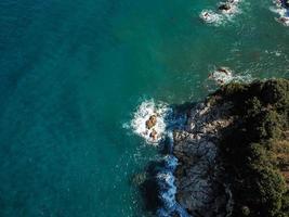 Drone top view of a sea cliff and a beach photo