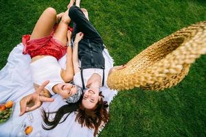 Top view, two young women lying in the park photo