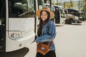 Girl wearing a hat and a vintage style dress is standing on a parking. photo