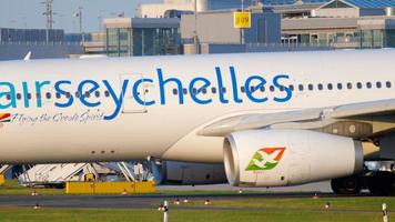 DUSSELDORF, GERMANY JULY 21, 2017 Air Seychelles Airbus 330 S7 VDM taxiing to the start at sunset. Dusseldorf airport video