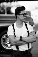 Guy in a shirt with suspenders posing at the retro car photo