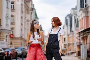 dos mujeres jóvenes caminando al aire libre divirtiéndose foto