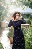 Girl in hat posing on camera photo