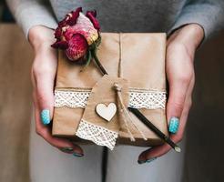 The girl holds in hands charming gift for her loved one photo