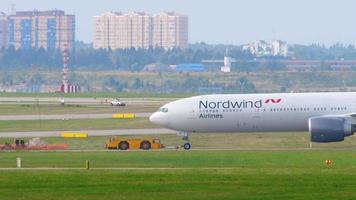 MOSCOW, RUSSIAN FEDERATION SEPTEMBER 12, 2020 - Nordwind Airlines Boeing 777 being towed by tow truck for departure from Sheremetyevo International Airport video