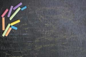 Multicolor chalk on backboard for education background photo