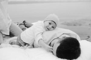 Happy young family relaxing together on the lake photo