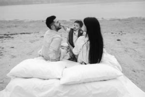 Happy family relaxing together on the mattress photo