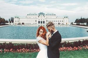 Wedding couple on a walk in the estate of the Belvedere in Vienna photo