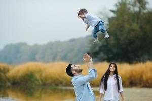 Dad throws up his young son photo