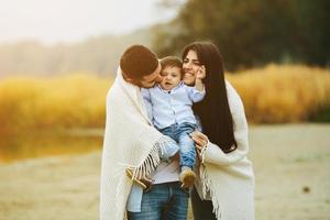 familia joven junta en la naturaleza con un niño pequeño foto