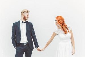 Wedding couple on a background of whitewall photo