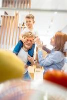 Dad mom and little son play in the bedroom with paper boxes photo