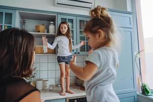 Happy family having fun in the kitchen photo