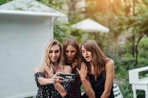 Three girls discuss photo