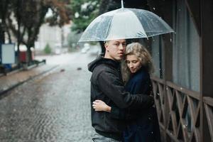 Couple on the street with umbrella photo