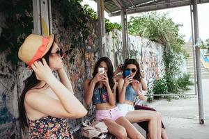 Four beautiful girls at the bus stop photo