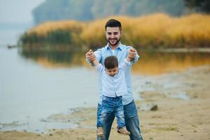 Dad holding infant son's hands photo