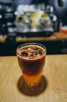 Glass with cold coffee and ice and orange. photo