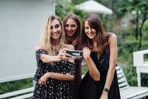 Three girls discuss photo