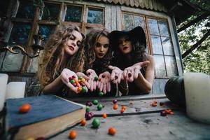 Three vintage witches perform magic ritual photo