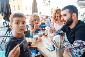 family in a cafe, mom takes a photo