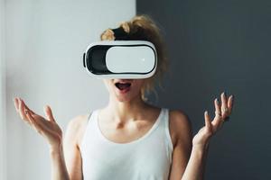 Woman in VR headset looking up photo
