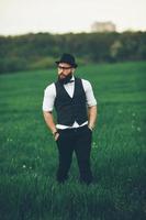 man with a beard, thinking in the field photo